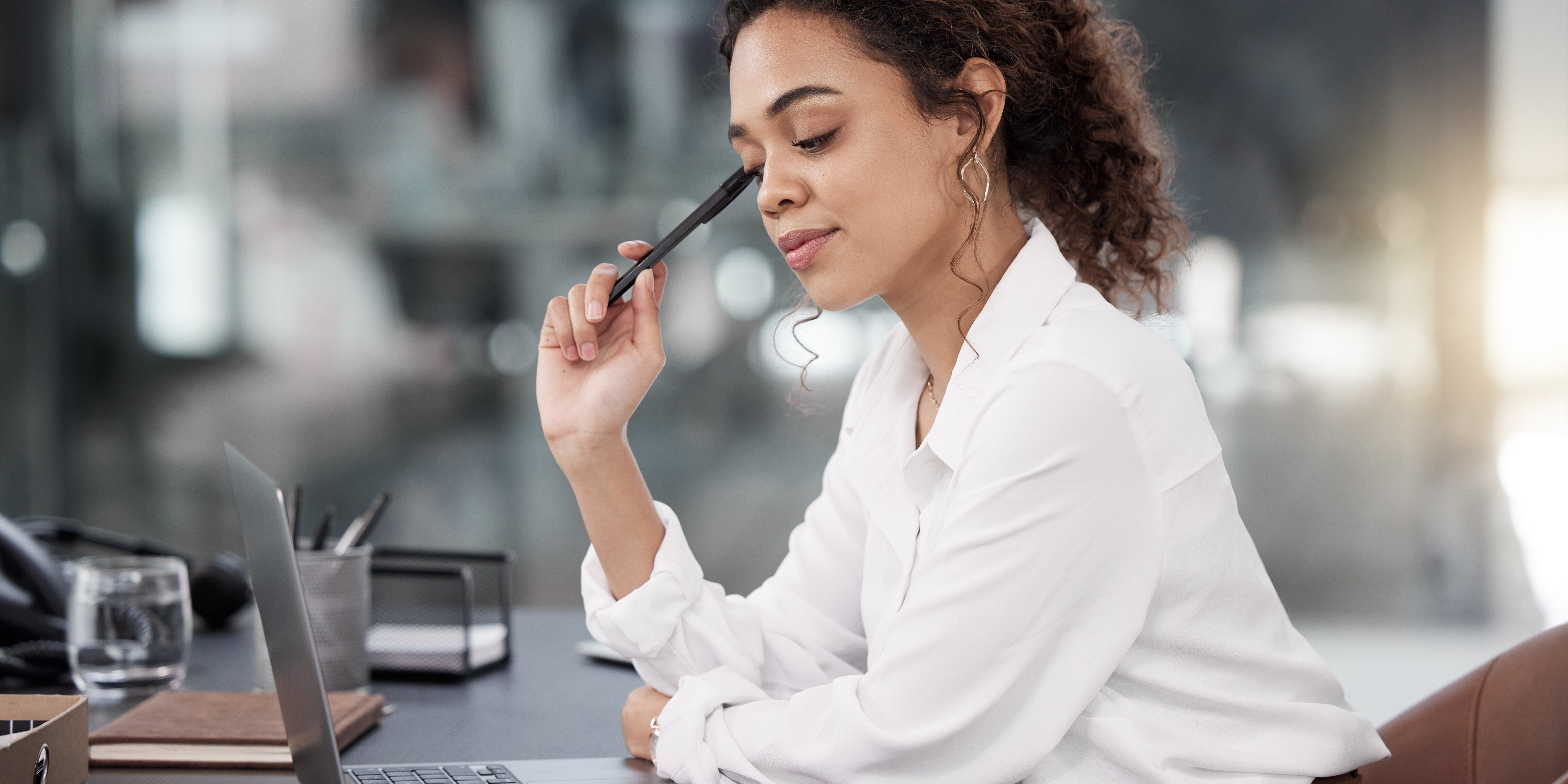 Business woman, laptop and thinking for strategy, planning or corporate decision on office desk. Female person or employee in wonder, choice or doubt on computer for project plan at the workplace.